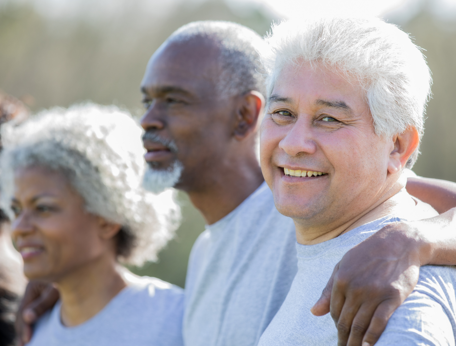 A caregiver with an older adult in a park
